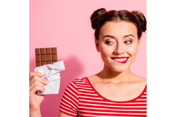 Image Woman eating chocolate.
